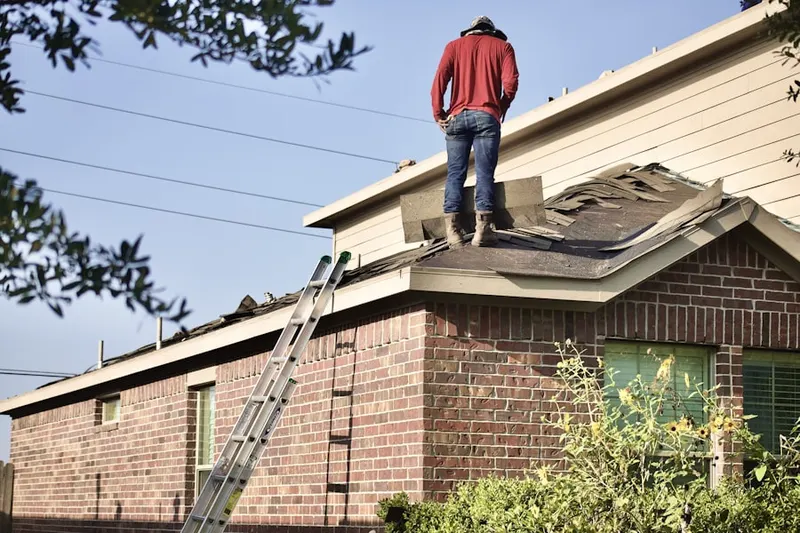Professional roofer working on a residential roof in Tagus